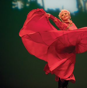 Weiwei Fu performs the Mongolian Dance in traditional Mongolian red costume on stage.