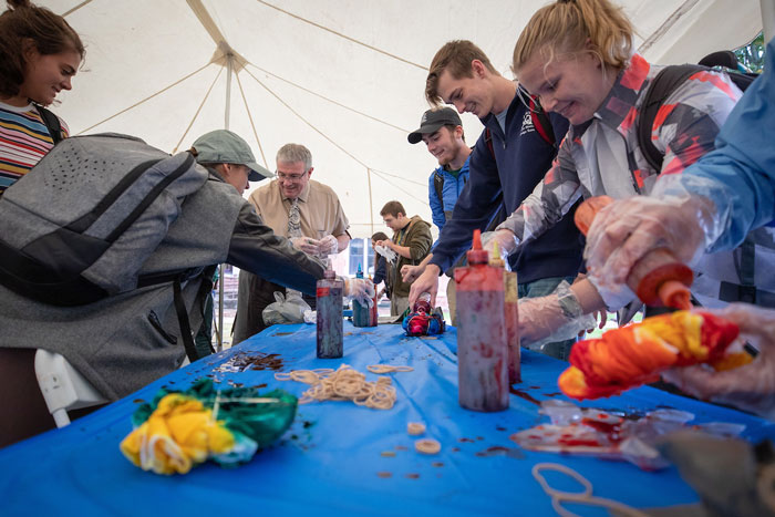 Students and interim chancellor Maples enjoy a tie-dye station at the libary golden celebration.