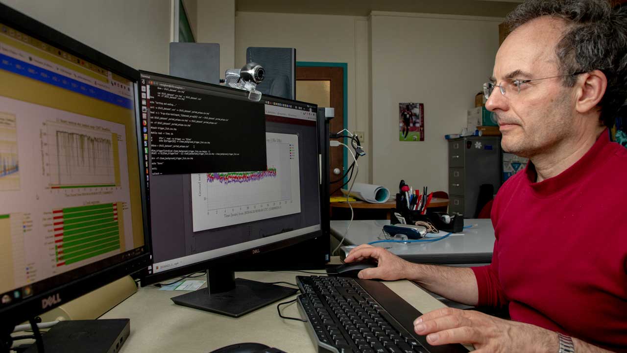 Marco Cavaglia, professor of physics at S&T sits at his working on astrophysics research
