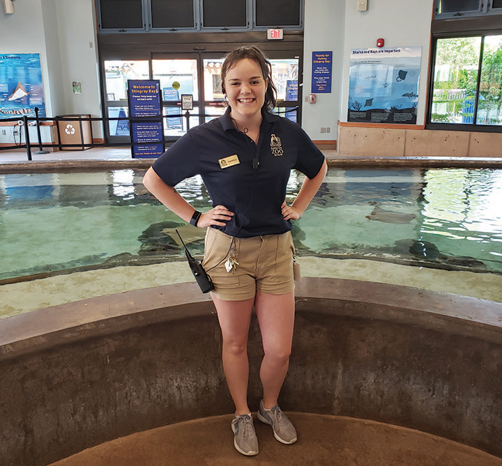 Vanessa Mahan stands in front of the stingray tank exhibit at Stingray Bay, Kansas City Zoo.