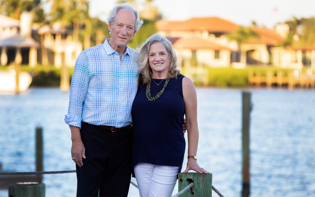 Mike and Linda Evans stand together on a dock.