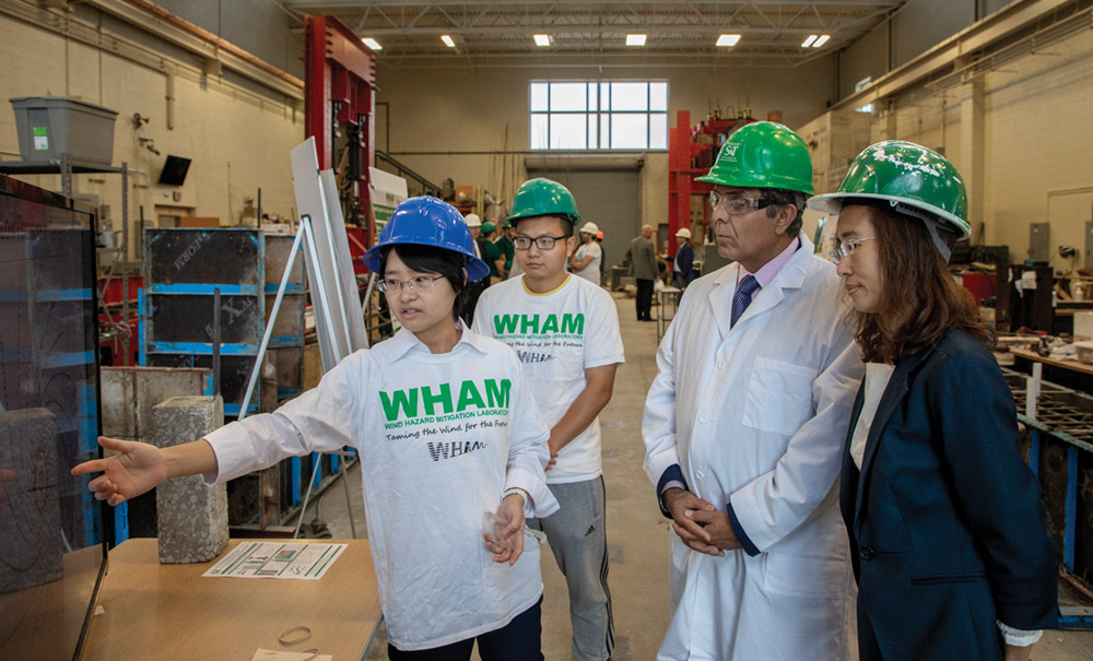 Guirong "Grace" Yan, assistant professor of civil, architectural and environmental engineering and director of the Wind Hazard Mitigation Laboratory, and her students demonstrate to Chancellor Dehghani her work to make "Tornado Alley" safer and more resilient. 